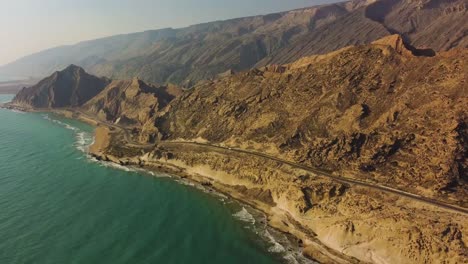 travel-to-rock-beach-in-sunset-time-summer-season-erosion-of-wind-on-mountain-wonderful-panoramic-wide-view-landscape-of-blue-color-harbor-horizon-in-a-hazy-day-in-Hormuz-island-natural-marine-iran