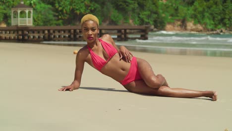 In-the-Caribbean-paradise,-a-young-woman-of-African-descent-delights-in-the-sun,-clad-in-a-red-bikini