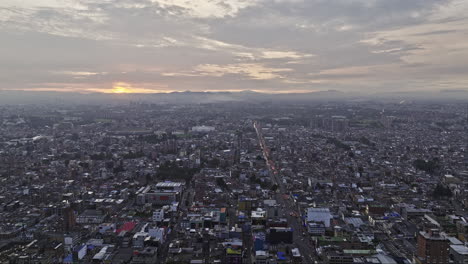 Bogota-Colombia-Aerial-v13-drone-flyover-San-Luis-along-Avenida-Calle-63-towards-El-Campin-capturing-cityscape-featuring-arena-and-stadium-with-sunset-views---Shot-with-Mavic-3-Cine---November-2022
