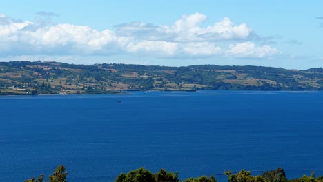 Chiloé-panoramic-and-distant-view-of-the-main-island-from-the-pier-of-Los-Brujos,-southern-Chile-on-a-sunny-day