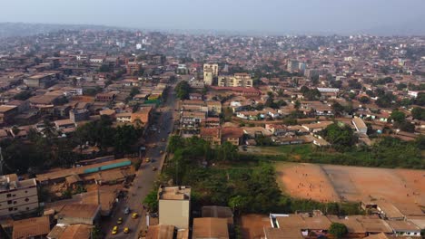 Drone-overview-of-soccer-fields-and-streets-in-the-outskirts-of-Yaounde,-Cameroon