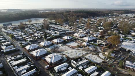 Aerial-establishing-of-Bungalow-park-community-covered-in-snow-in-Netherlands,-Orbiting-shot