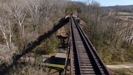Aerial-Shot-Pushing-Forward-Along-the-Tracks-of-the-Pope-Lick-Railroad-Trestle-in-Louisville-Kentucky-on-a-Sunny-Winter-Day