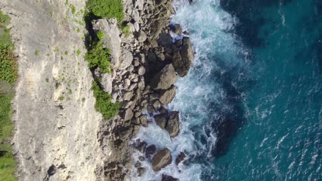 Rocky-cliff-coastline-and-blue-ocean-of-Atlantic,-top-down-view