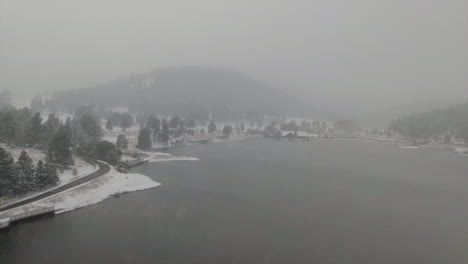 Downtown-Evergreen-Lake-house-foggy-Colorado-historic-downtown-aerial-drone-blizzard-fall-autumn-winter-first-snowfall-foggy-Rocky-Mountain-front-range-Denver-backward-slowly-motion