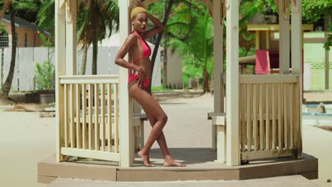 On-the-white-sandy-shores-of-the-Caribbean,-a-black-girl-in-a-red-bikini-enjoys-the-day