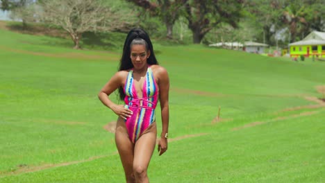 A-young-lady-in-a-bikini-embraces-the-open-field-surroundings-on-the-tropical-Caribbean-island-of-Trinidad