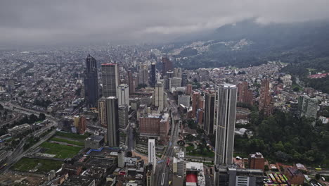 Bogota-Colombia-Aerial-v32-drone-flyover-Carrera-10-across-Alameda,-International-Center-and-Santa-Fe-capturing-downtown-cityscape-with-ominous-storm-clouds---Shot-with-Mavic-3-Cine---November-2022