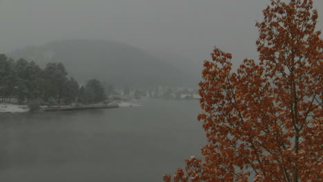 Yellow-tree-downtown-Evergreen-Lake-house-foggy-Colorado-historic-downtown-aerial-drone-blizzard-fall-autumn-winter-first-snowfall-foggy-Rocky-Mountain-front-range-Denver-left-slowly-motion-reveal