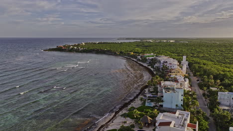 Akumal-Mexico-Aerial-v9-drone-fly-along-coastline-capturing-seafront-vacation-homes,-resort-hotels,-lush-landscape-of-tropical-plantations-and-ocean-views---Shot-with-Mavic-3-Pro-Cine---July-2023