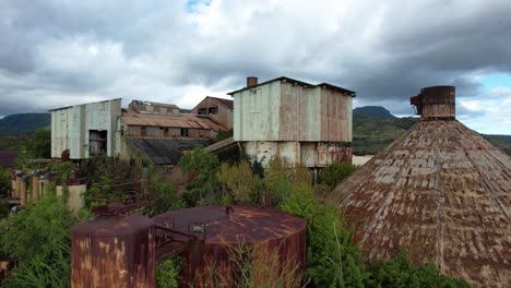 koloa-sugar-mill-abandoned-factory-in-kauai-hawaii,-aerial-tilt