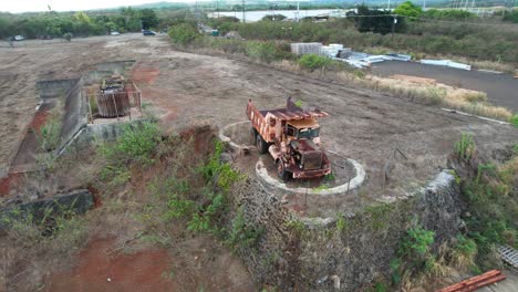 Circle-view-of-old-derelict-truck-on-Hawaii-koloa-sugar-mill,-aerial