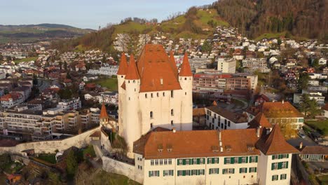 Medieval-Thun-castle-and-towers-on-hill-above-town-center,-Switzerland