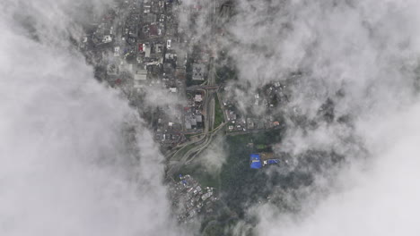 Bogota-Colombia-Aerial-v9-high-altitude-vertical-drone-flyover-La-Paz-hillside-capturing-satellite-view-across-Alameda-and-Santa-Fe-through-white-clouds---Shot-with-Mavic-3-Cine---November-2022