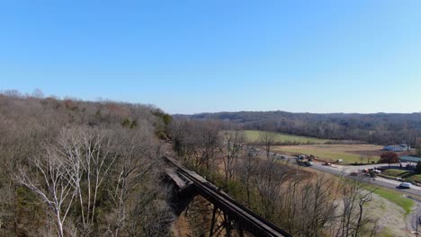 Aerial-Shot-of-Railroad-Tracks-Winding-Out-of-a-Forest-and-on-to-the-Pope-Lick-Trestle-in-Louisville-Kentucky