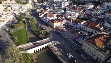Aerial-orbit-shot-of-Ferragudo-old-town-center-in-Algarve,-fishing-village-in-South-Portugal