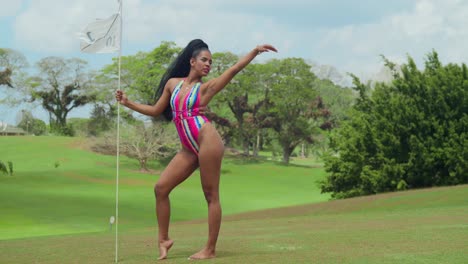 In-the-midst-of-a-golf-course-in-Trinidad,-a-girl-in-swimwear-takes-in-the-tropical-beauty