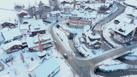 Zooming-out-shot-of-snowy-Kandersteg-town-in-winter,-Switzerland