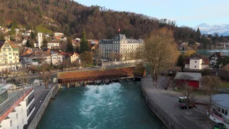 Flowing-sluice-and-bridge-of-river-Aare-in-historic-Thun-town-center