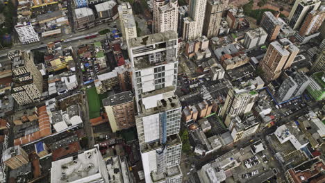 Bogota-Colombia-Aerial-v26-birds-eye-view,-drone-fly-around-BD-Bacata-tallest-building-capturing-cityscape-across-Germania,-La-Paz,-Santa-Fe-and-downtown---Shot-with-Mavic-3-Cine---November-2022