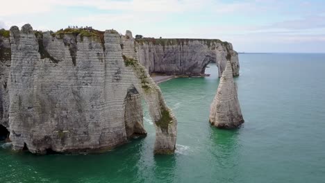 Flying-upward-looking-at-the-rocky-arch-of-Etretat-in-Normandy