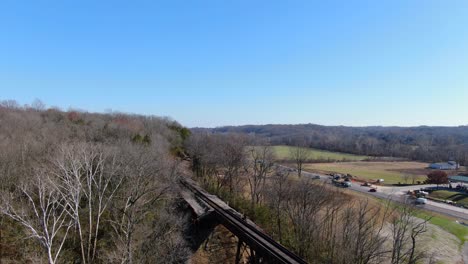 Aerial-Shot-of-Railroad-Tracks-Winding-Out-of-a-Forest-and-on-to-the-Pope-Lick-Trestle-in-Louisville-Kentucky