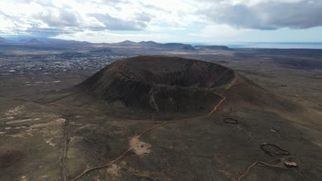 caldera-volcano-crater-aerial-in-Fuerteventura,-panoramic-drone-shot,-bright-sunny-day
