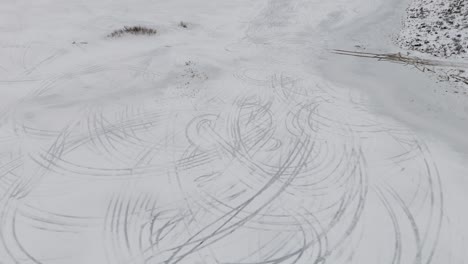 Drone-captures-intricate-car-tracks-left-by-drifting-cars-on-the-icy-surface