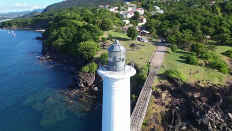 Old-lighthouse-at-Vieux-Fort-in-Guadeloupe,-aerial-orbit-view