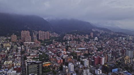 Bogota-Colombia-Aerial-v15-panoramic-flyover-Chapinero-capturing-hillside-La-Salle-neighborhood,-cityscape-and-mountainous-terrain-with-misty-clouds-in-the-sky---Shot-with-Mavic-3-Cine---November-2022