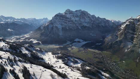 Swiss-Alps-village-aerial-view-of-mountains-range-Switzerland-winter-snow