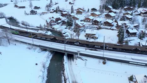 Cars-driving-in-car-shuttle-train-in-snowy-winter-town-railway-station