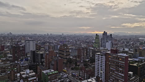 Bogota-Colombia-Aerial-v16-cinematic-low-level-drone-flyover-Chapinero,-La-Salle-and-Teusaquillo-neighborhoods-capturing-urban-cityscape-at-dusk-sunset---Shot-with-Mavic-3-Cine---November-2022