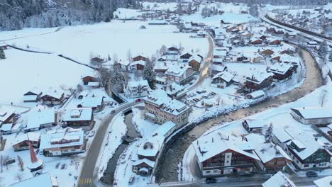 Snowy-Kandersteg-town-in-Switzerland-with-flowing-river-in-winter