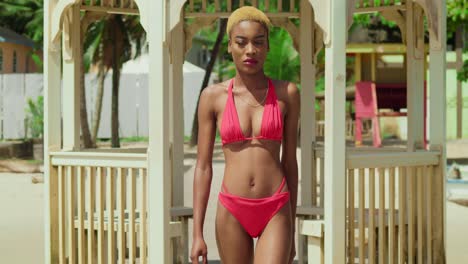 On-the-sun-kissed-shores-of-the-Caribbean,-a-girl-with-ebony-skin-enjoys-the-day-in-her-red-bikini