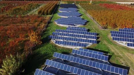 Revolutionary-agriculture-fueled-by-a-solar-panel-array-in-rural-Greece,-dolly-in-aerial-perspective