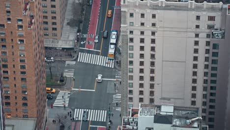 Top-view-between-buildings-of-mild-street-car-traffic-in-New-York-City