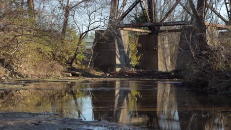 Slow-Pan-Up-from-a-Stream-to-Show-the-Supports-of-the-Pope-Lick-Railroad-Trestle-in-Louisville-Kentucky
