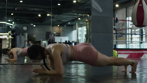 girl-asiatic-oriental-woman-performing-abs-exercise-at-gym-with-mirror