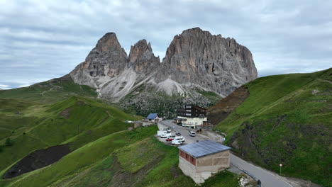 Canazei-establishing-aerial-view-alpine-mountain-in-the-Fassa-valley-resort,-Northern-Italy