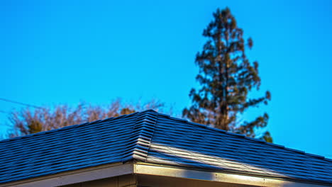 Time-lapse-of-snow-and-frost-melting-from-a-house-roof,-sunny-winter-morning