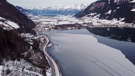 Frozen-Zell-Lake-in-Austria,-alpine-lake,-valley-view-with-mountains,-aerial