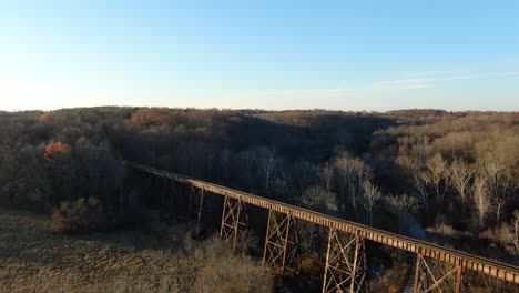 Aerial-Shot-Pushing-Forward-and-Panning-Down-to-the-Pope-Lick-Railroad-Trestle-in-Louisville-Kentucky-at-Sunset