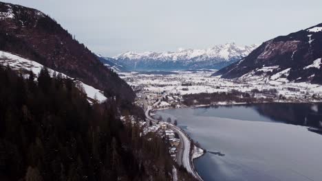 Frozen-Zell-lake-in-Austrian-mountain-alps,-aerial-view-in-winter,-snow-covered
