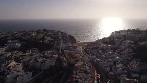 Sunset-in-small-village-Carvoeiro-in-Portugal,-tourist-destination-for-vacation,-aerial
