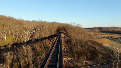 Aerial-Shot-Pushing-Forward-Along-the-Pope-Lick-Railroad-Trestle-in-Louisville-Kentucky-During-the-Sunset