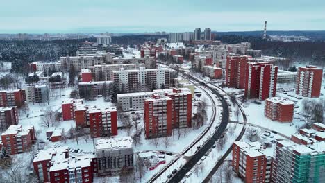 Winter-view-from-a-drone,-buildings-of-Vilnius,-Lithuania-covered-in-snow