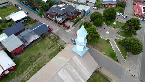 Aerial-orbit-over-the-patrimonial-church-of-Dalcahue-on-the-big-island-of-Chiloé,-Chile