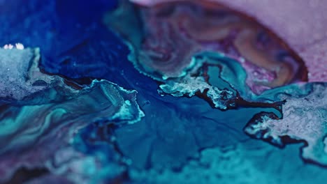 Vivid-close-up-of-blue-and-pink-ink-diffusing-in-water,-creating-an-abstract-fluid-art