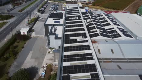 Nahaufnahme-Eines-Fluges-über-Eine-Solarpanelfarm,-Die-Auf-Dem-Dach-Eines-Anlagenkomplexes-Installiert-Ist